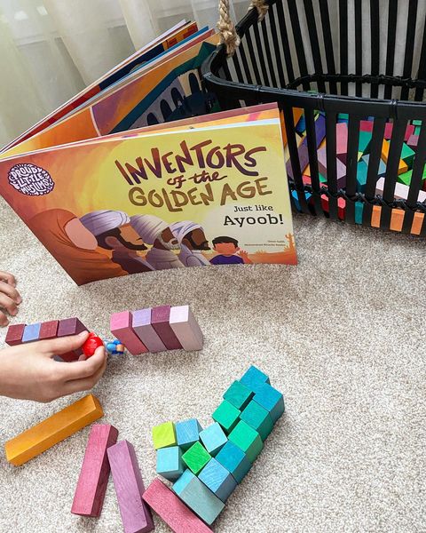 Child plays imaginatively using blocks to role play the stories inside their Personalised Muslim Children's book by Proud Little Muslims about the Islamic Golden Age called Inventors of the Golden Age: Just like you!